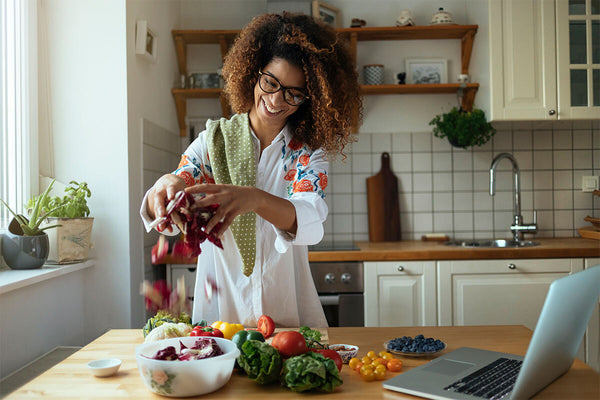 Photo of woman preparing a healthy meal of fruits and vegetables