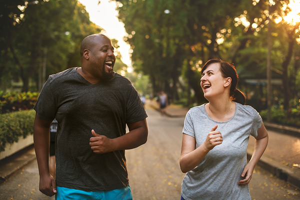 2 people laughing while jogging
