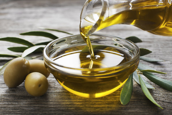 Photo of olive oil in a bowl on a table