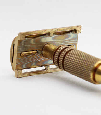 Natural heat patina on a copper and brass mokume gane safety razor for wetshaving