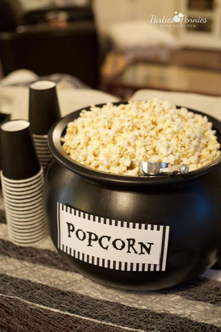 plastic halloween prop cauldron filled with popcorn