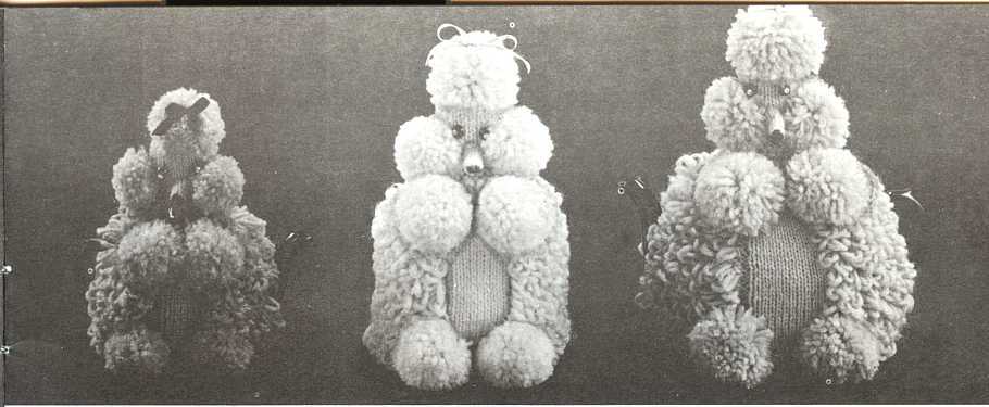 a black and white scanned photo with three knitted poodle toilet roll covers sitting in a line. on the left is a small one, the middle is a larger one and the right is a big daddy.