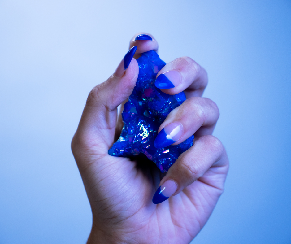 girl holding a sapphire crystal in her hand