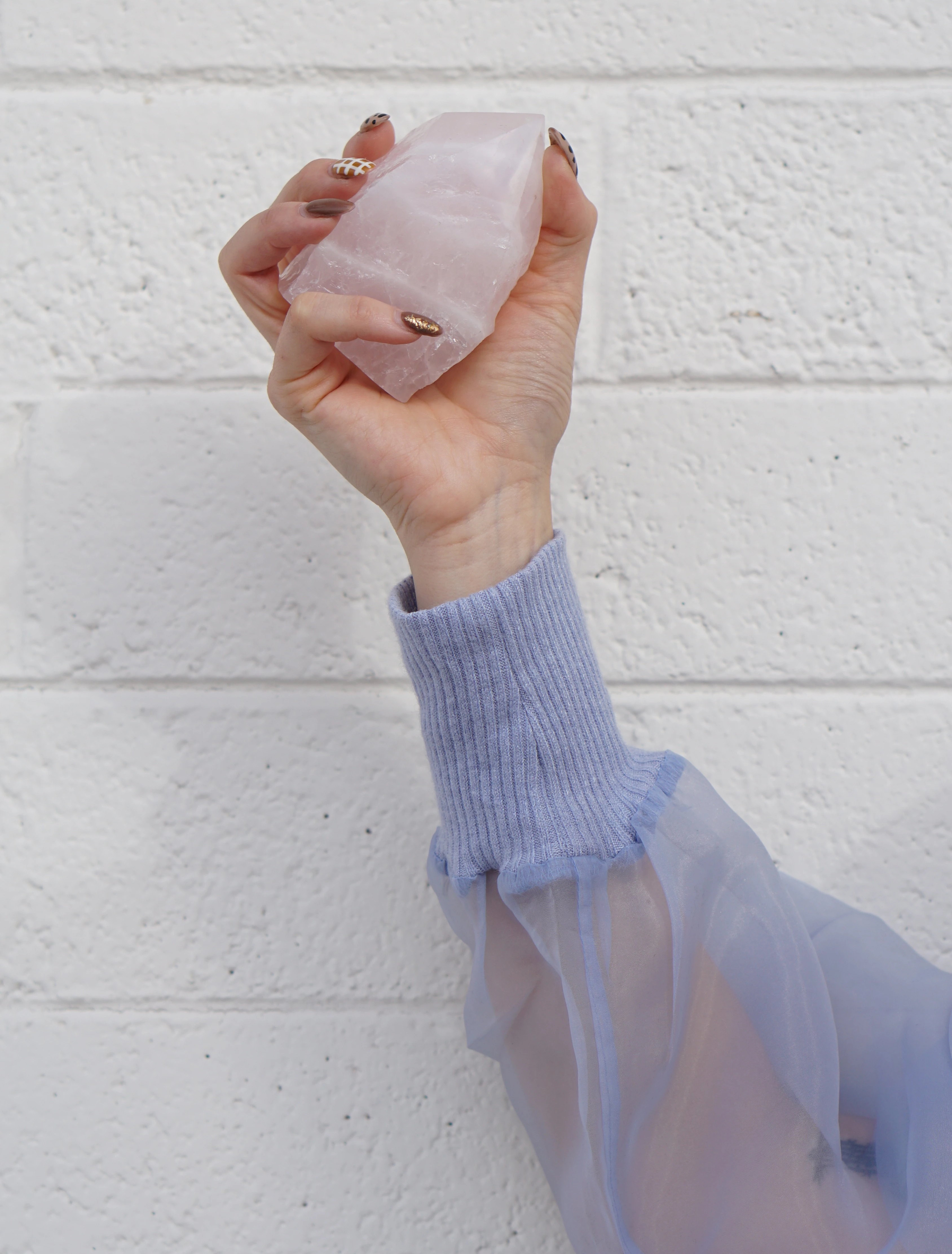 girl holding a rose quartz crystal
