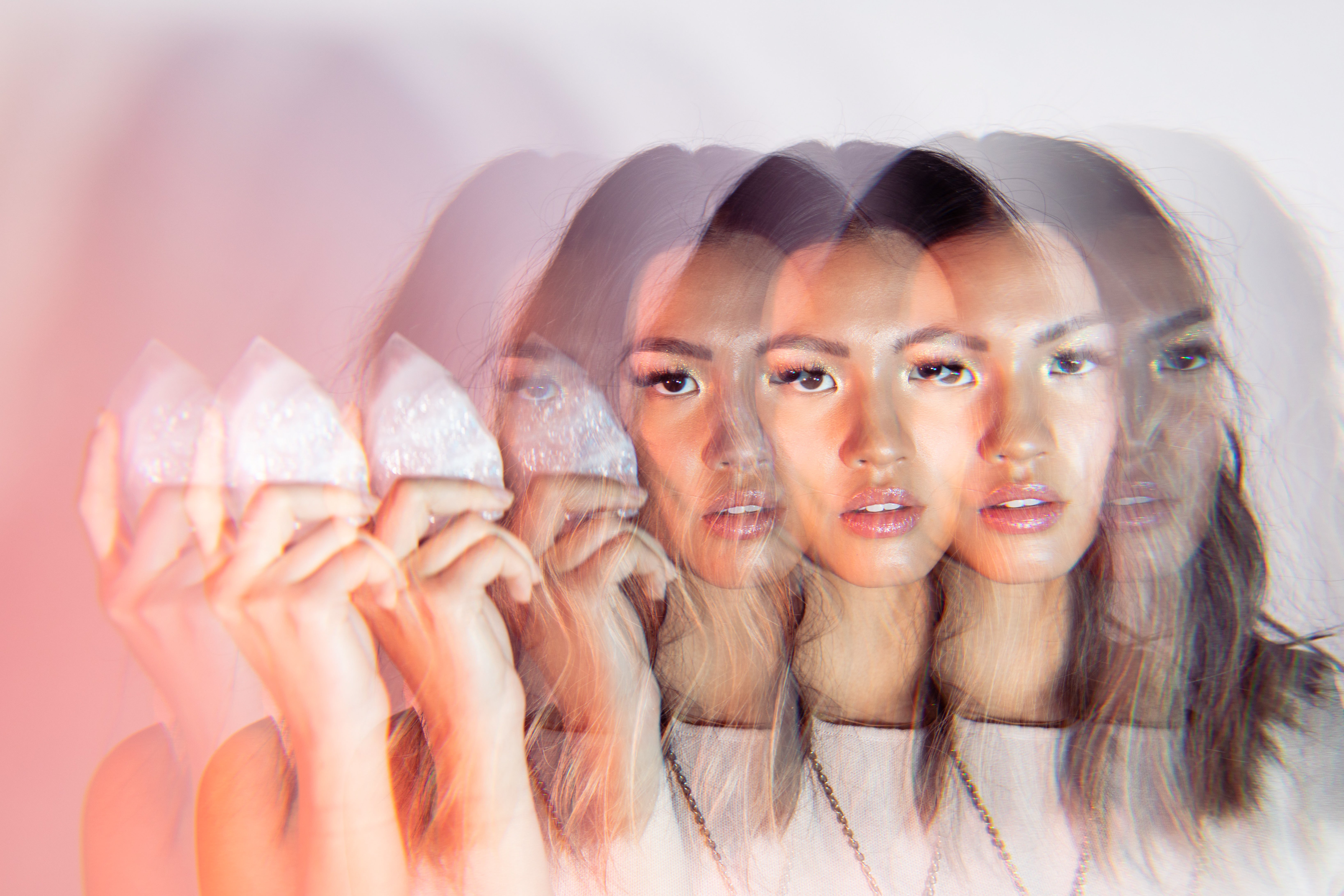 girl holding a rose quartz crystal point