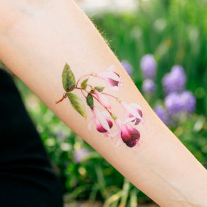 Pink watercolor flower tattoo