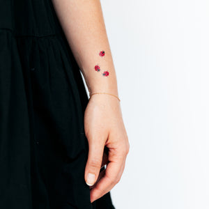 Small ladybug tattoo on the left wrist
