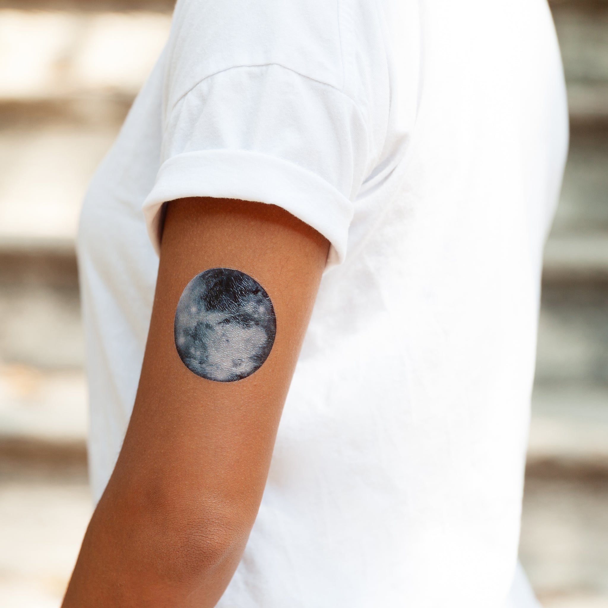 Minimalist moon phases tattoo on the inner forearm