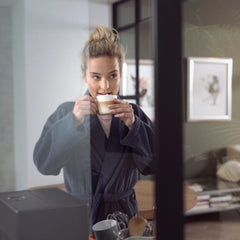 Woman enjoying a coffee in her home