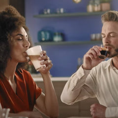 Couple enjoying cappuccino and espresso made from a Philips Superautomatic Espresso Machine available at Espresso Canada