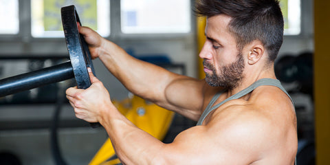 Bodybuilder racking a plate