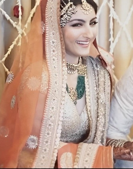 Soha Ali Khan in golden and green stone bridal jewellery