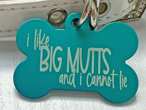 I Like Big Mutts quote engraved on bone-shaped pet tag for large breeds