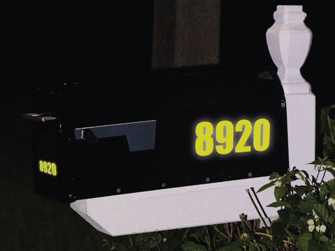 reflective mailbox decal in yellow on black mailbox at night