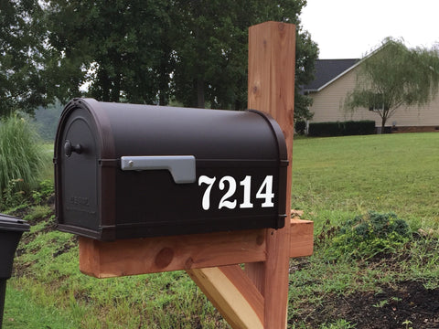 Brown mailbox with a white street number mailbox decal