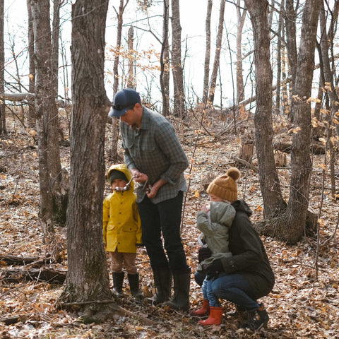 The Mohagen family tapping maple trees for syrup production.