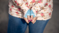 a woman's hands showing off hoodies with thumbholes
