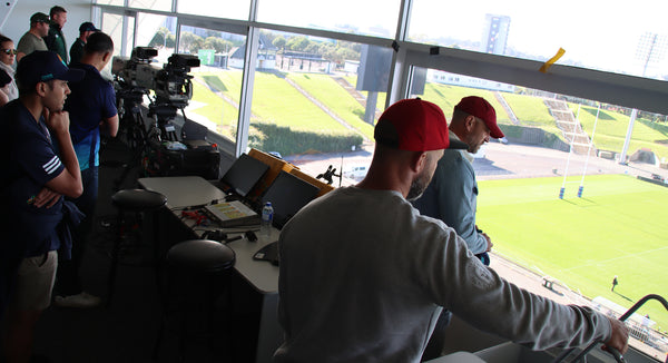 Guests look out onto the Mount Smart Stadium Field from inside the commentators booth