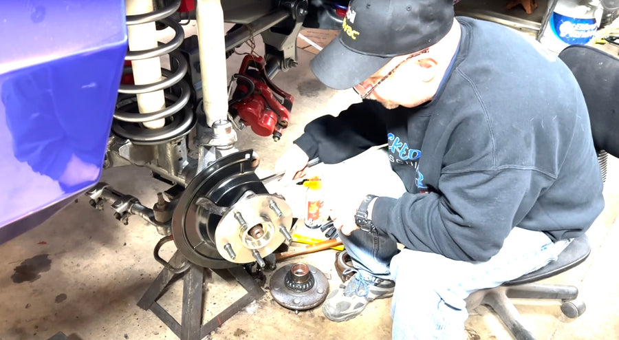 Man installing new wheel hub on 2nd gen Dodge Ram 1500