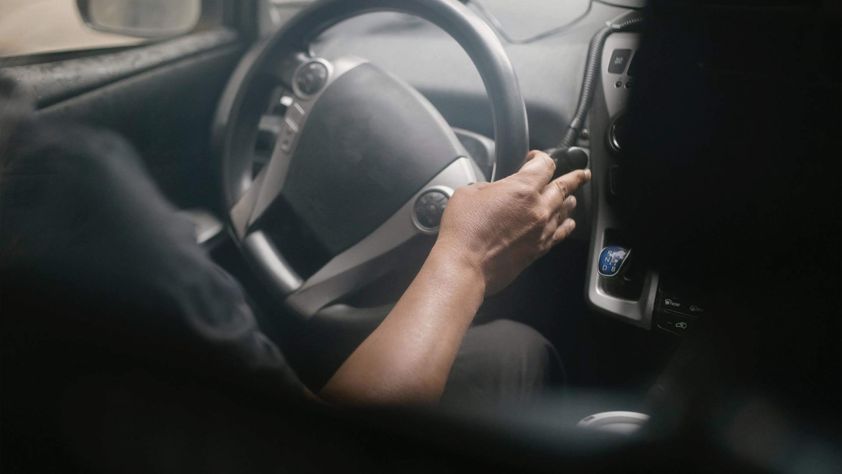 man using steering wheel in car