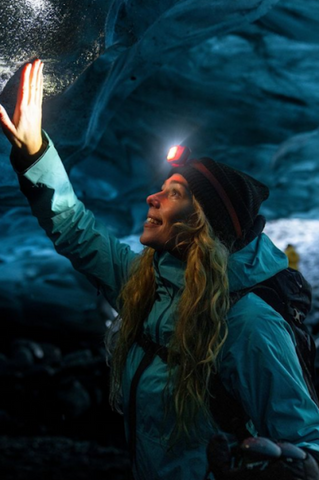 camper with headtorch in cave