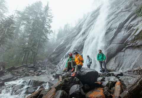 campers in front of waterfall