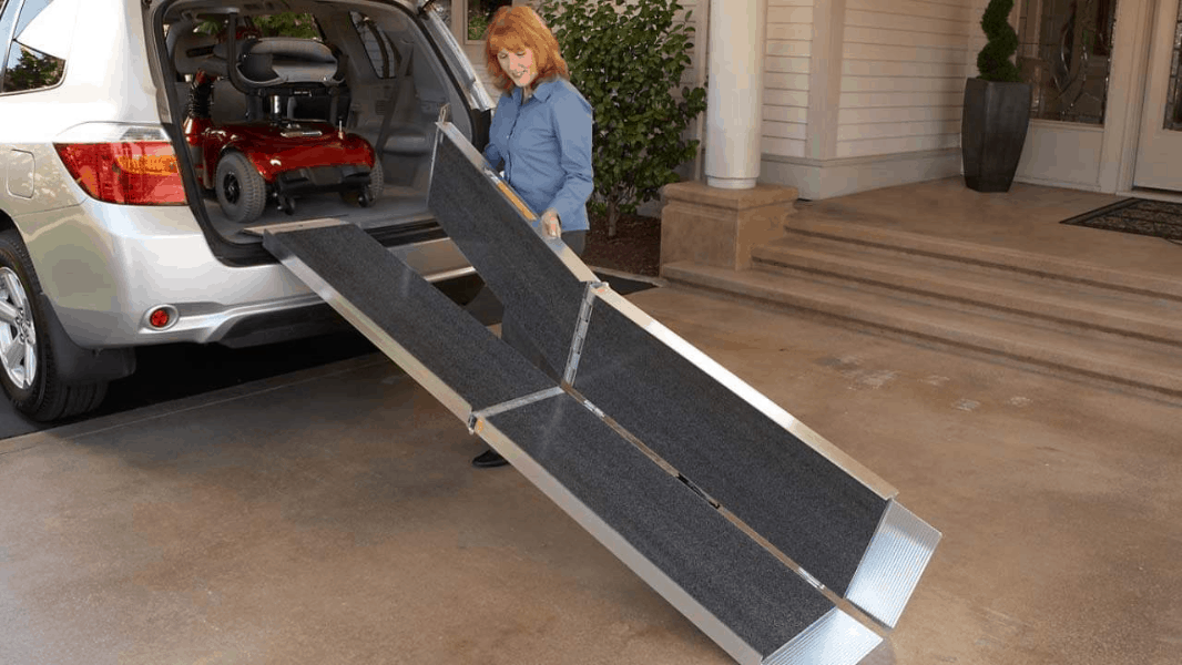 Woman Loading Suitcase Trifold AS by EZ-ACCESS to her van | Wheelchair Liberty