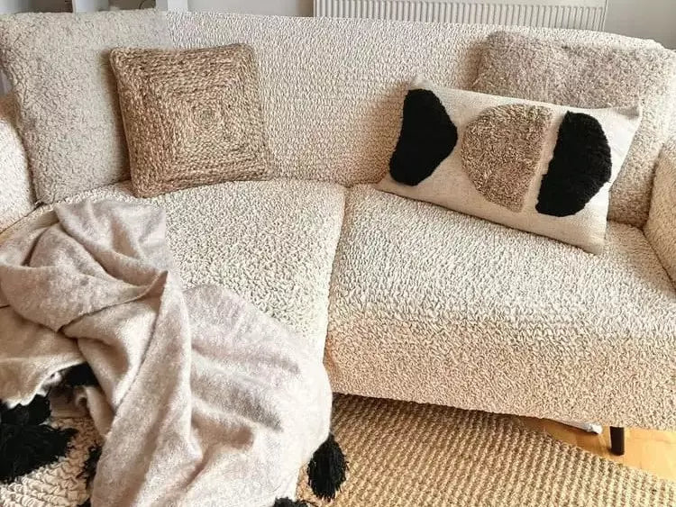 sofa with pillows and blanket