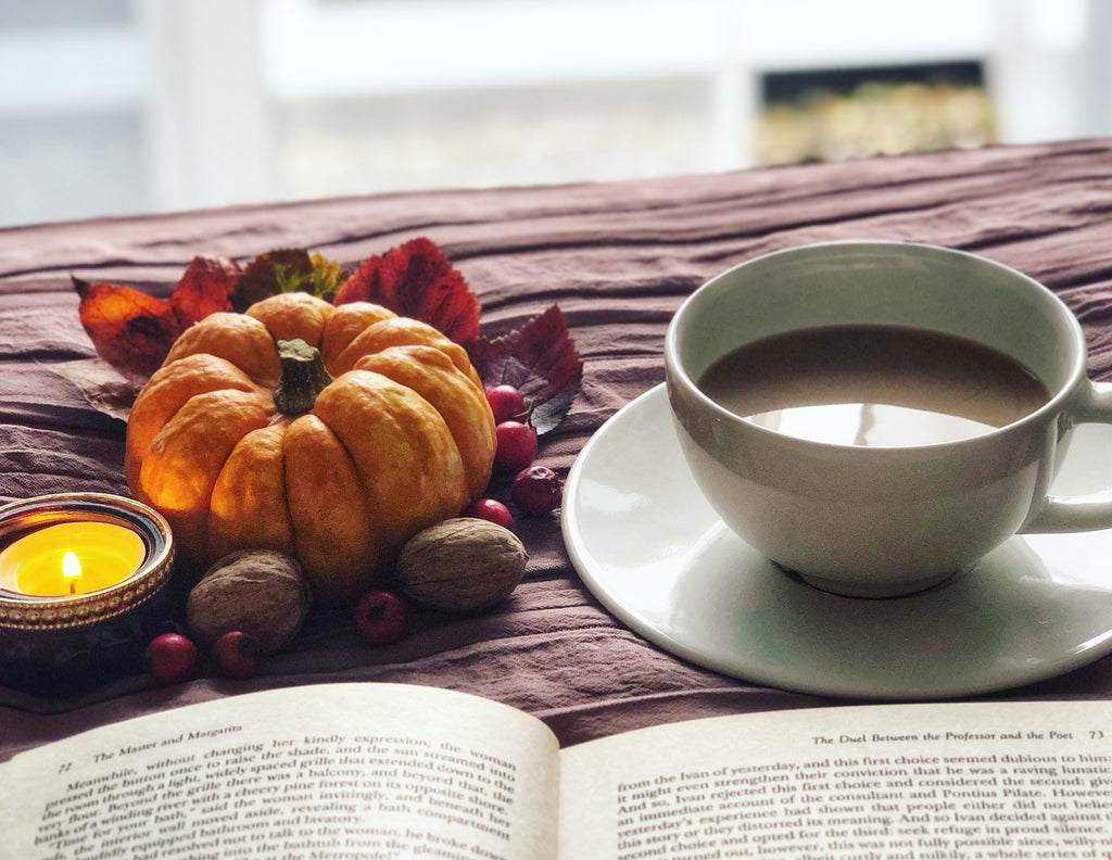 cup of coffee and pumpkin with candle