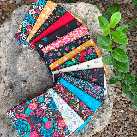 floral fat quarters folded laying on a rock