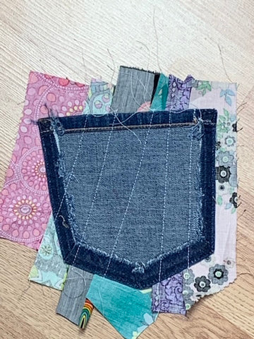 back side of jeans pocket with fabric strips stitched in place