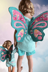 Girl and doll wearing butterfly wings made by sewmuchonline