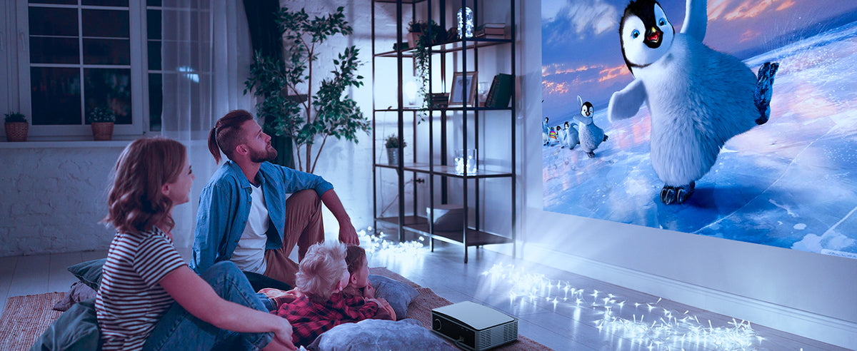 A family watching movies in the living room with PJ30 LCD Projector.