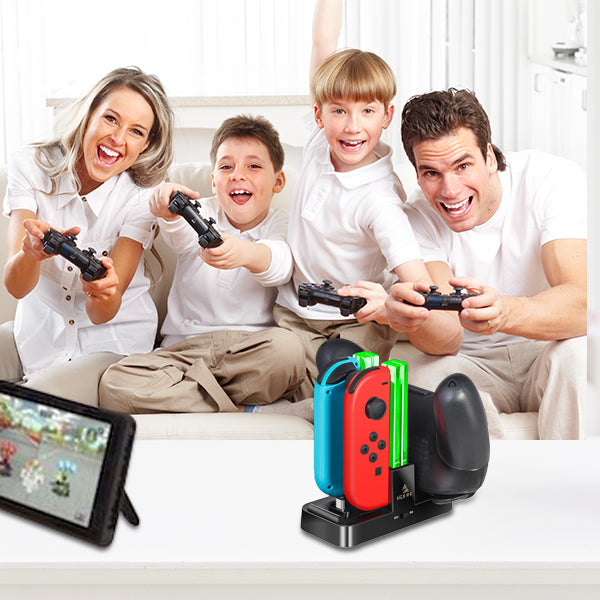 A family of four is playing Switch games with a charging dock nearby
