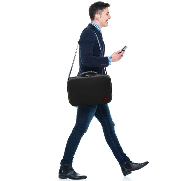 A man carrying the travel case on his shoulder