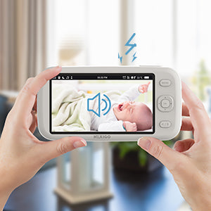 A person uses the monitor to remotely hear the baby's sound.