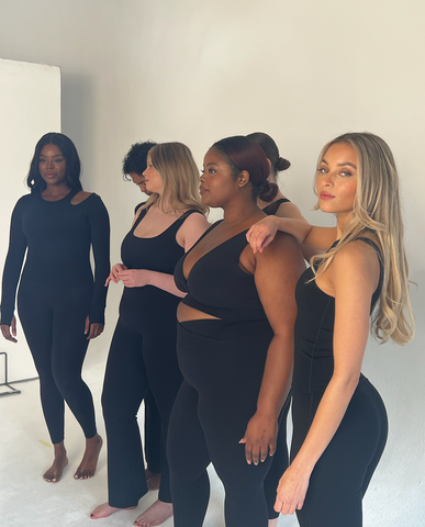 group of models wearing black tala outfits