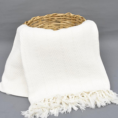 COTTON WHITE Blanket hangin from a basket