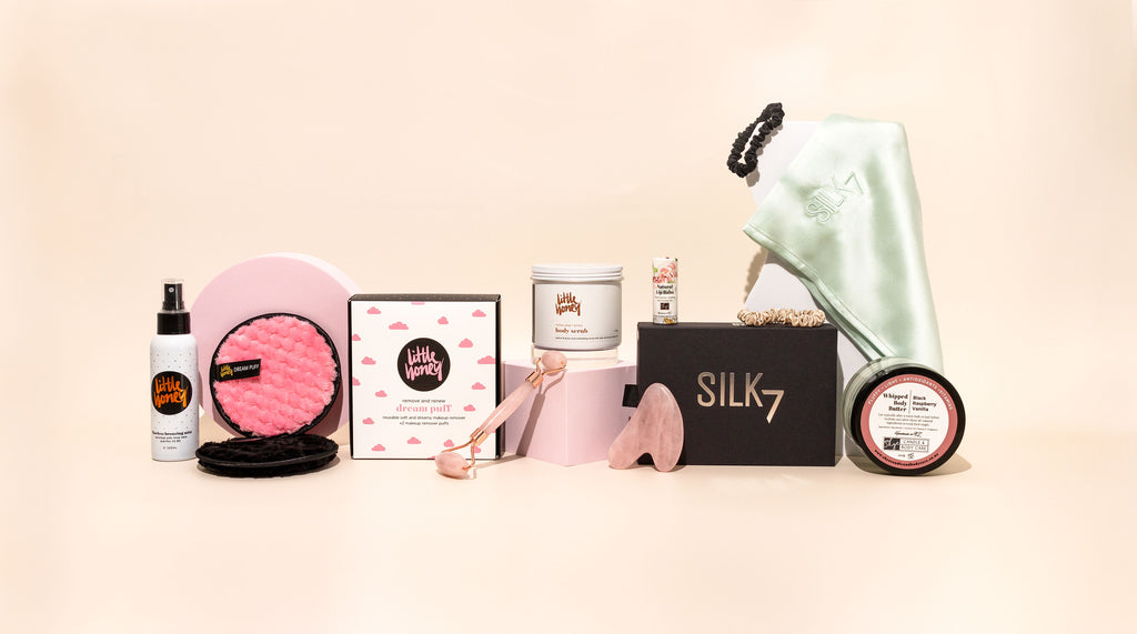 Magnolia Beauty Online makeup and skincare products lay side by side with pink background.