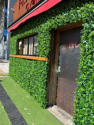 A cafe surrounded by artificial greenwall