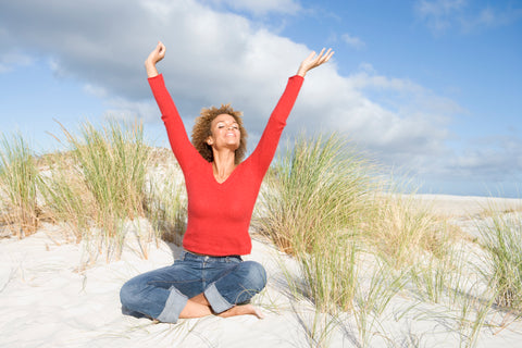 young-woman-stretching-amongst-sand-dunes