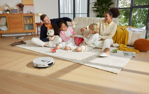 Roborock S7 Max Ultra cleaning wood floors while kids play nearby.