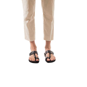 Model wearing David brown, handmade leather slide sandals with toe loop 