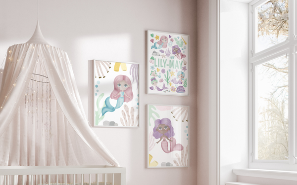 Set of 3 personalised mermids prints displayed next to a cot in a little girls nursery.