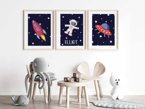 Set of 3 space nursery prints with a rocket and space ship in red. the middle print has an astonaut on i and is personalised with a child's name underneath. 