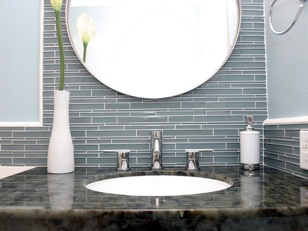 beautiful bathroom vanity with dark gray glass tile, granite top, round mirror, & flower... Bathroom Design Trends: Gorgeous Gray Inspiration