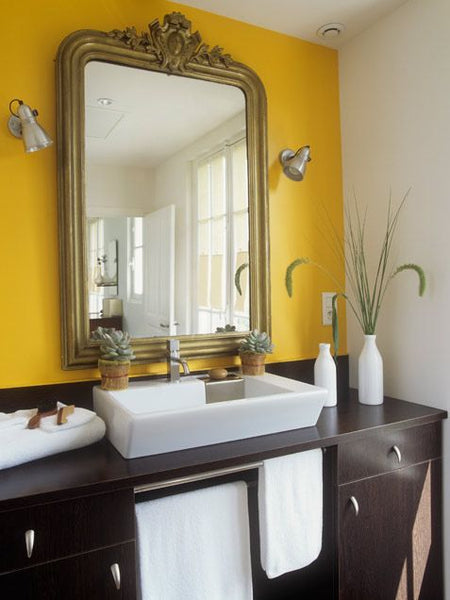 bright yellow bathroom with oversized mirror, white accents, dark wooden cabinets... Trending in Bathroom Design: Yellow Bathrooms from Bathroom Bliss by Rotator Rod