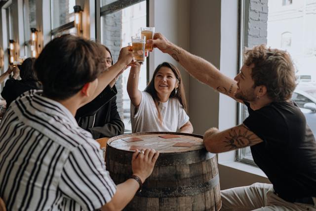 A group of friends toasting beers