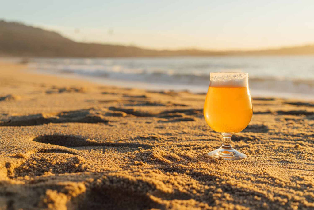 A glass of beer on a beach