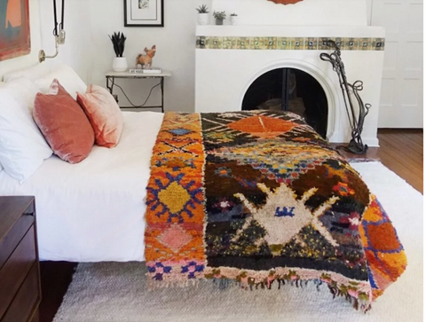 bed with rug and bedspread